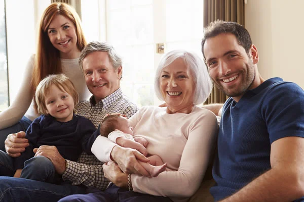 Happy family of three generations who successfully invested their finances as a result of good retirement planning
